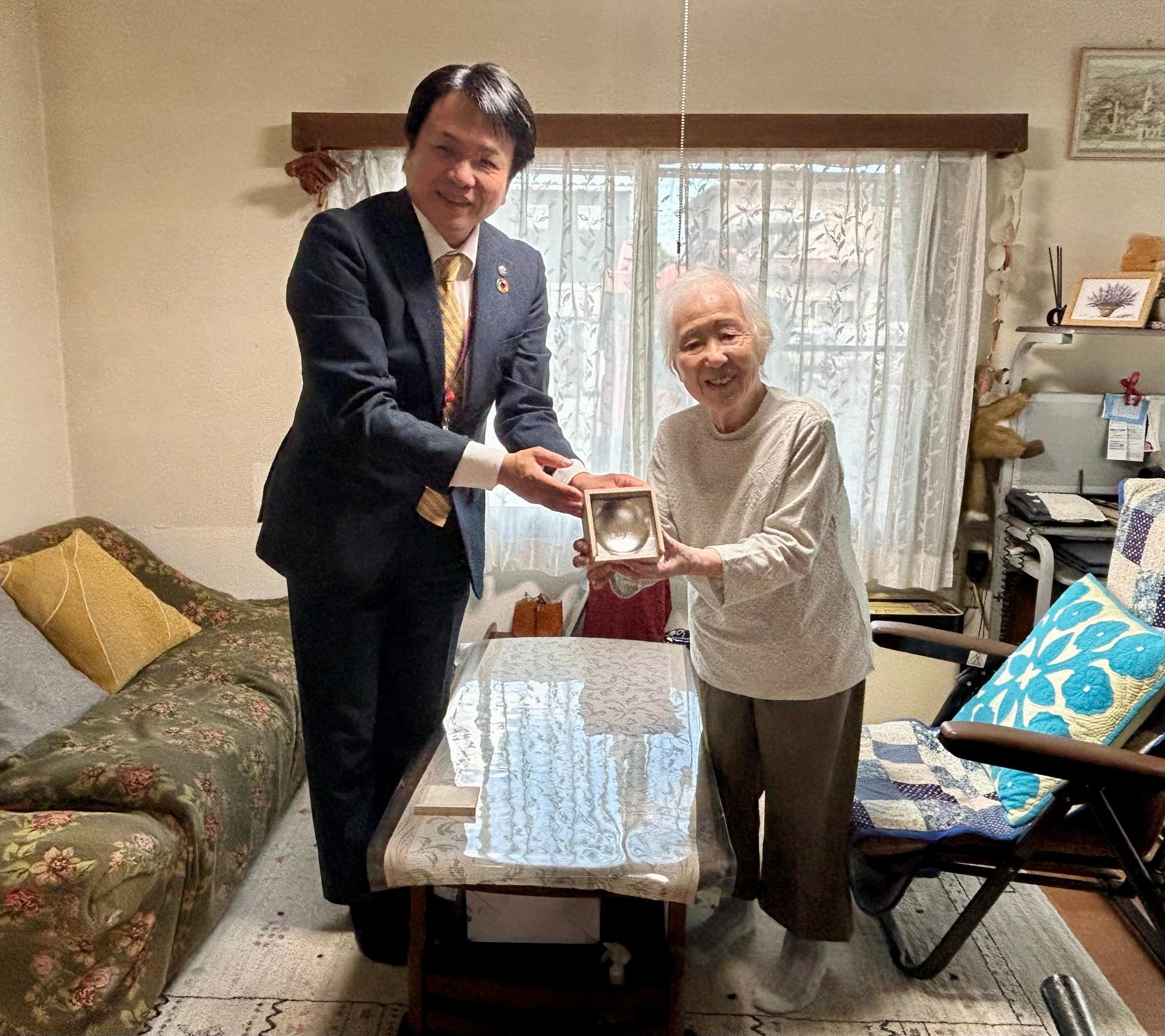 銀杯を持つ市長と長寿者