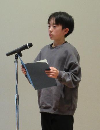 作文を朗読する児童の写真