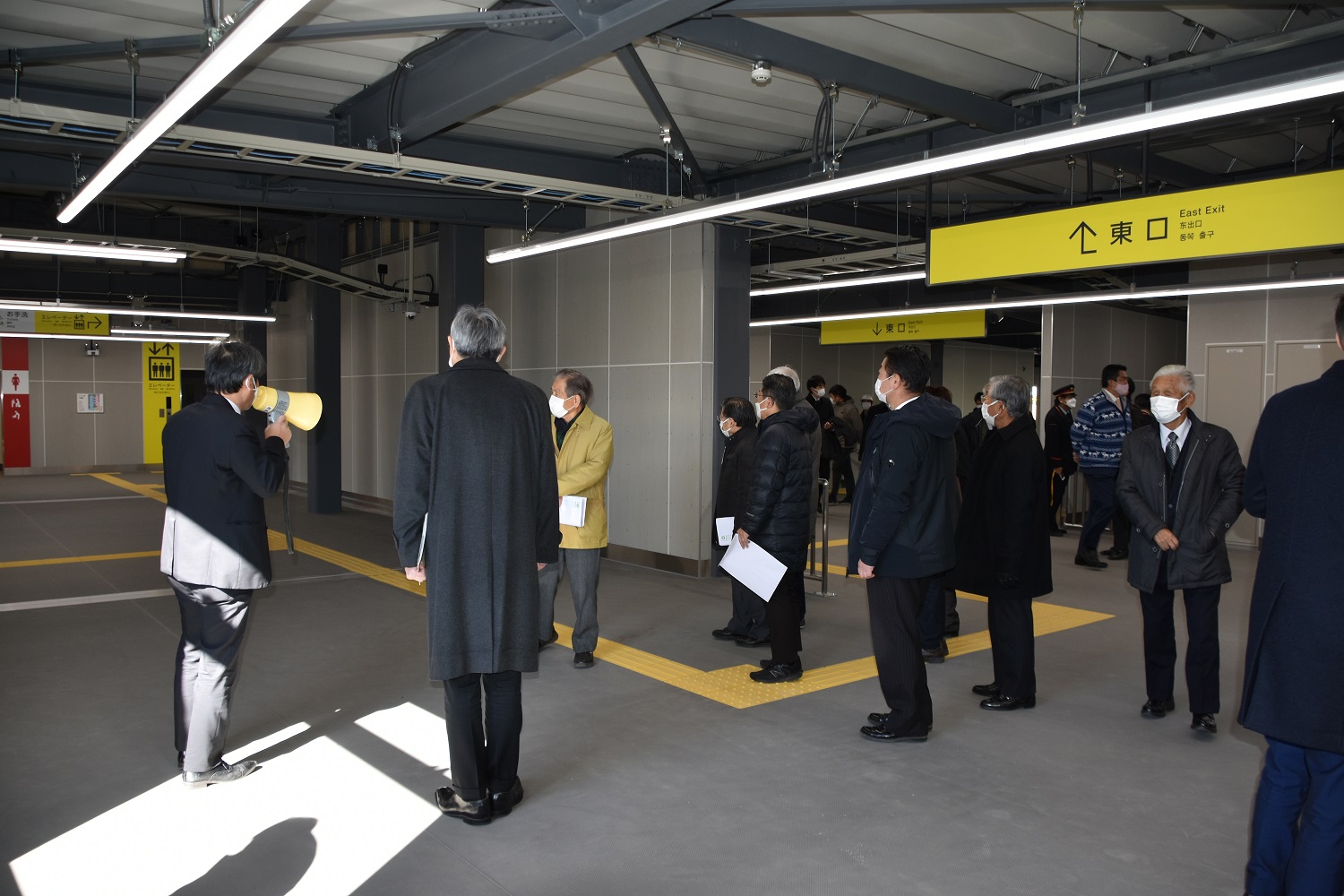 仮駅舎2階で担当者の説明を受ける同盟会会員一同の写真