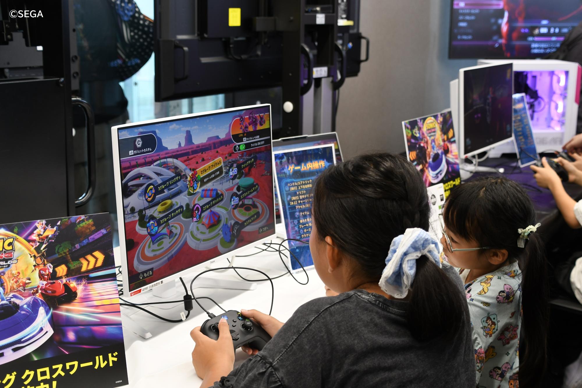 レーシングゲームで遊ぶ2人の女の子の写真
