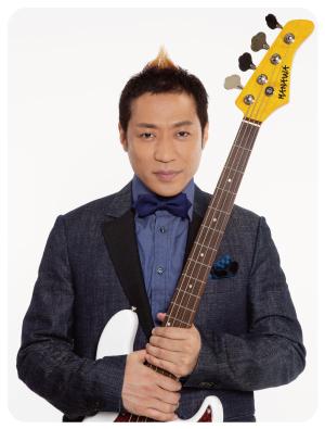 ジャケットを着て蝶ネクタイを付けエレキギターを構えるお笑い芸人はなわさんの写真