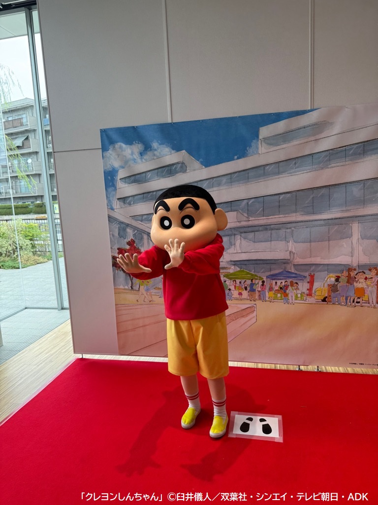 フォトスポット前で手をふる野原しんのすけくん